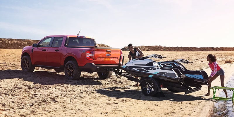 Ford Maverick pulling trailer with jetski.