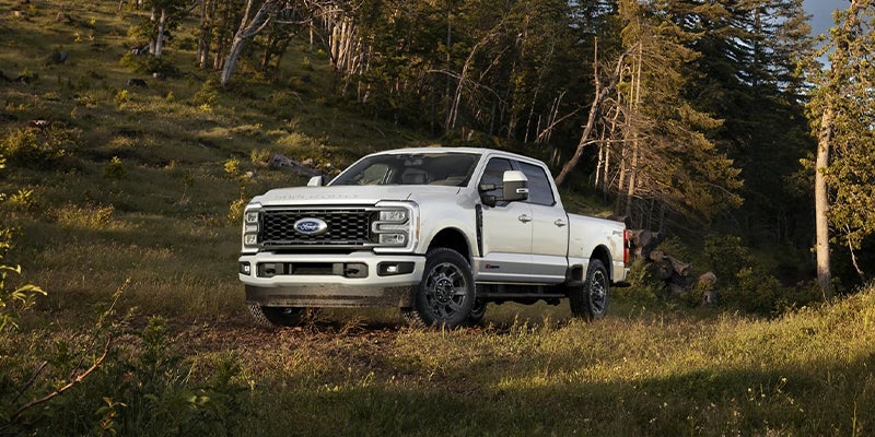2023 Ford Super Duty in white driving off road