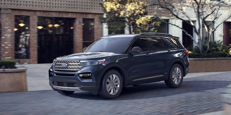 2024 Ford Explorer in blue driving on cobblestone in town