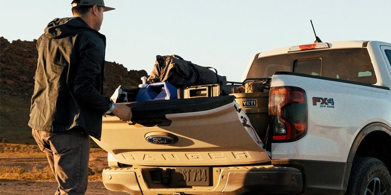 Man closing the tailgate of a Ford Ranger