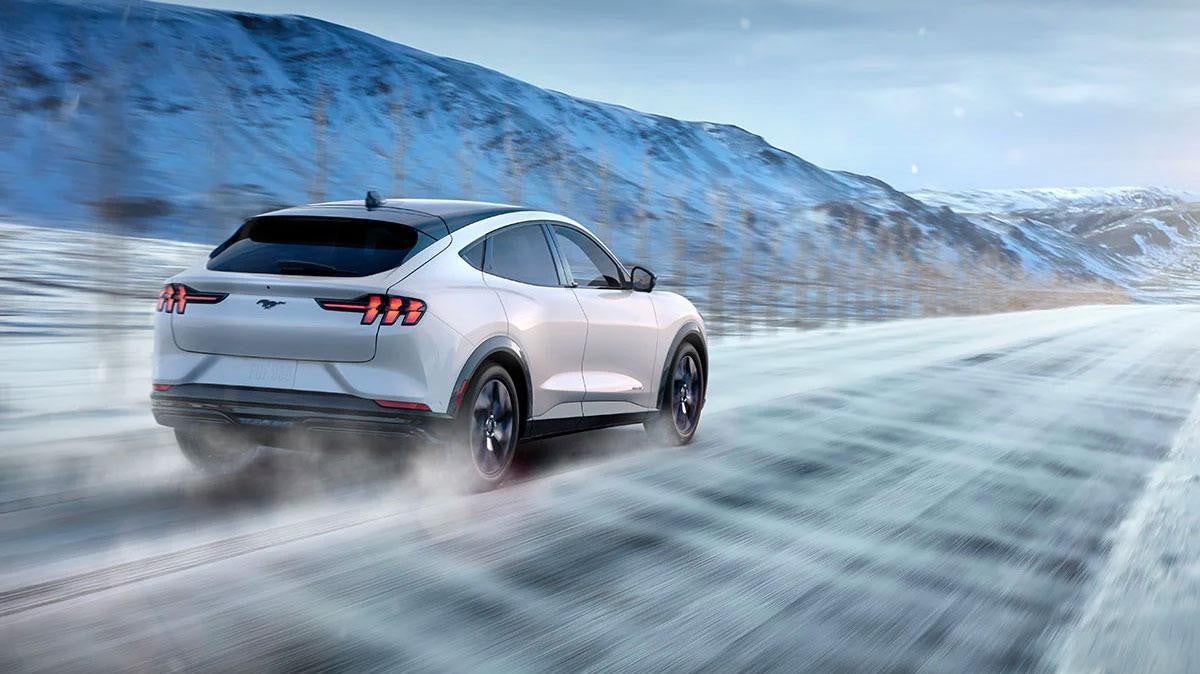 2021 Ford Mustang Mach-E driving through the snow
