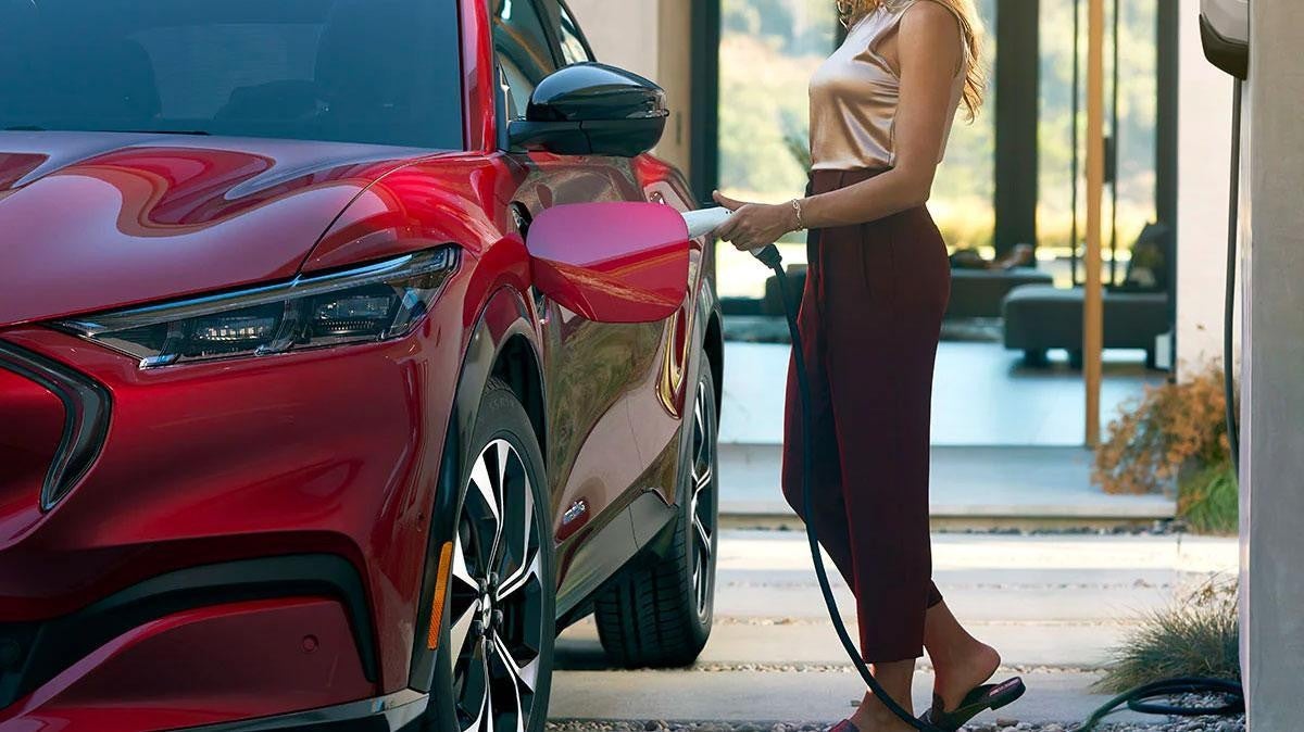 Woman charging a 2021 Ford Mustang Mach-E