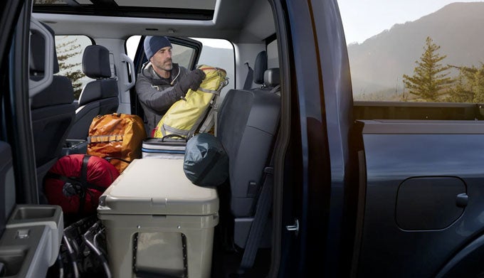 Man packing gear in a Ford F-150