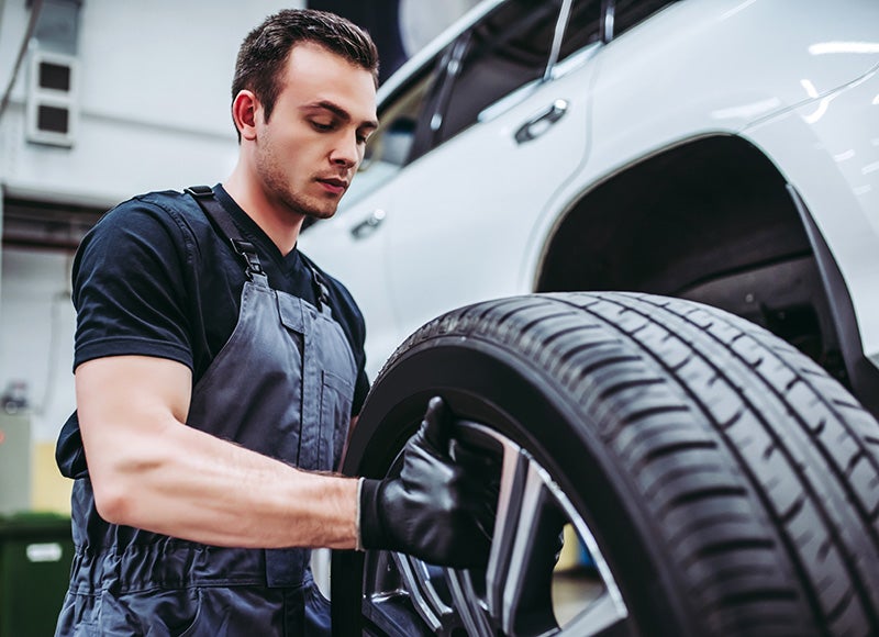 Technician handling car tire